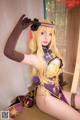 A woman in a purple and gold outfit is posing for a picture.