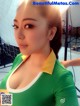 A woman in a green and yellow shirt posing for a picture.