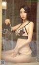 A woman in lingerie sitting in front of a mirror.